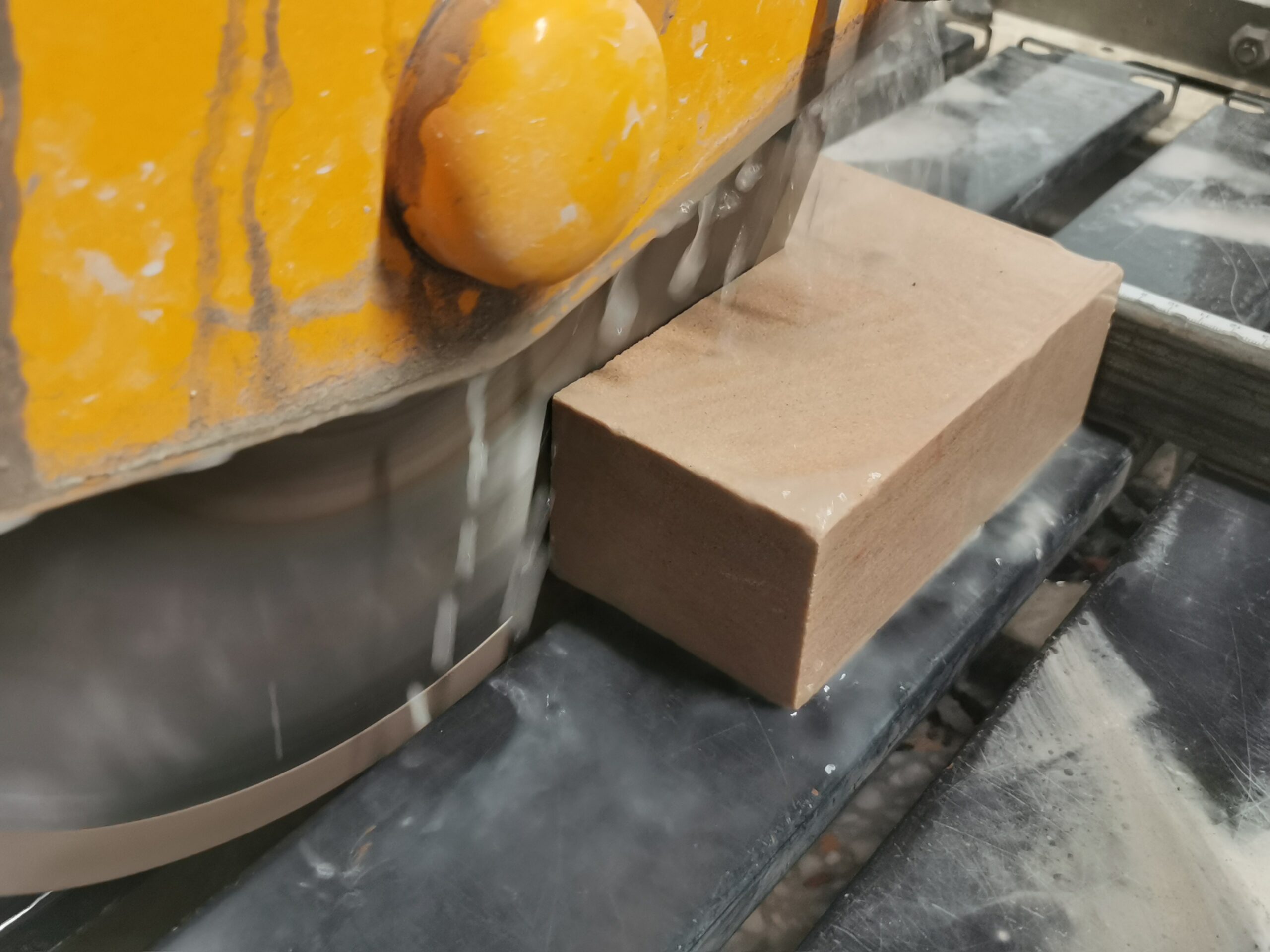 Image showing block of stone being wet sawed