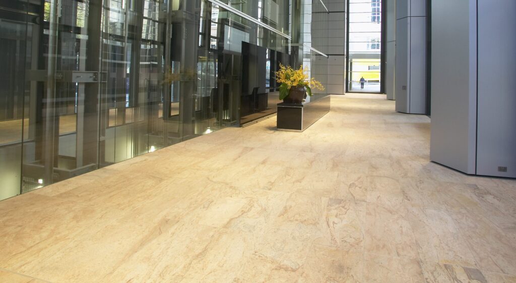 Image of lobby foyer at Deutsche Bank Place, showing lifts and wide expanse of stone flooring.