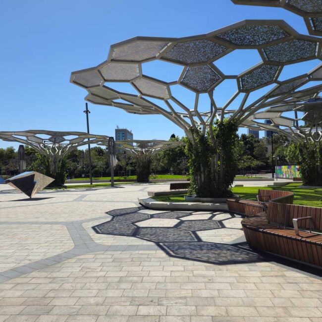 Image of Adelaide Festival Square showing geometric artwork shade structure and tiled flooring surface.