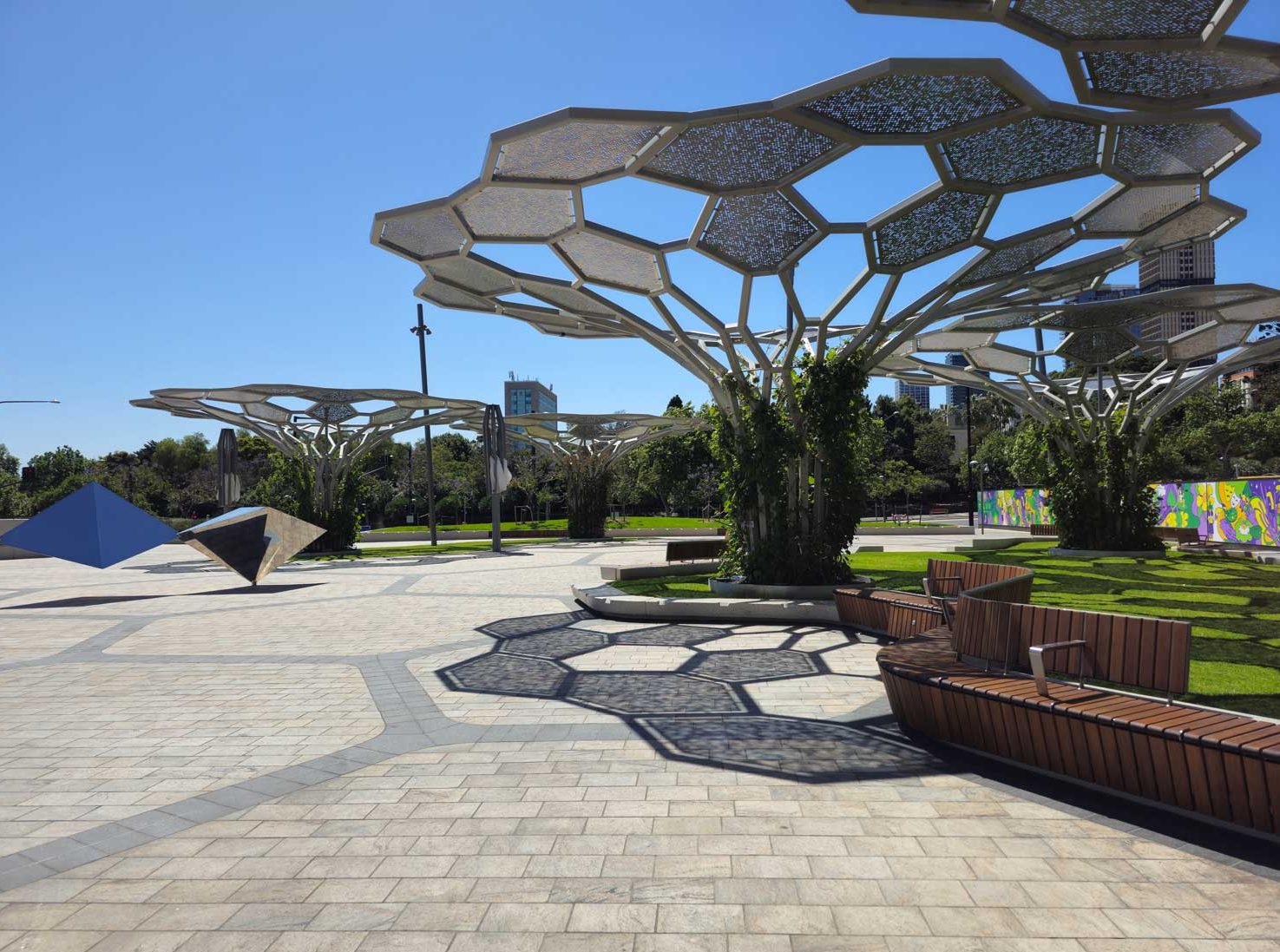 Image of Adelaide Festival Square showing geometric artwork shade structure and tiled flooring surface.