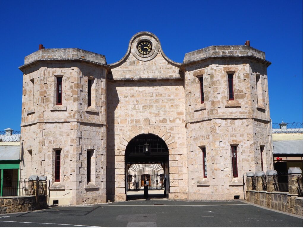 Image of Fremantle Prison Gatehouse with vibrant blue sky behind it.