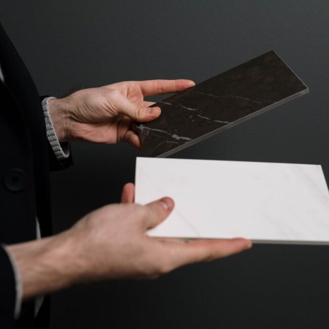 white and black marble tiles in hands